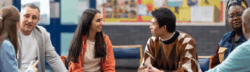 A small group of people sitting in a circle having a discussion in a community or classroom setting.